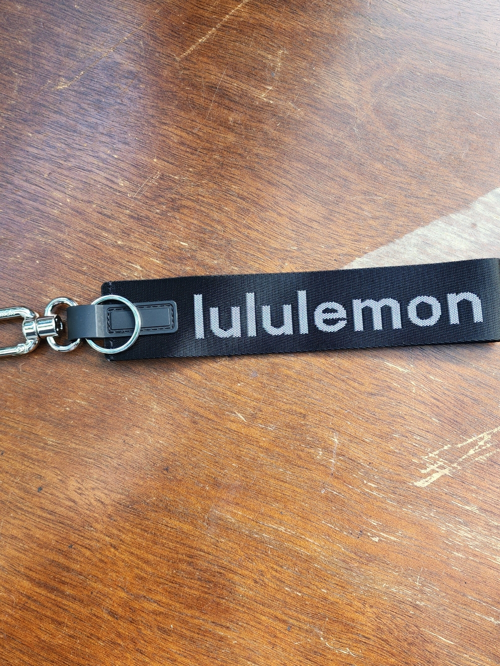 Lululemon Never Lost Keychain Black White Silver Lettering Wordmark